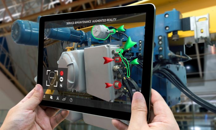 A tablet running the app "Service and Maintenance Augmented Reality" which shows parts of interest on an image recorded by a camera to a technician