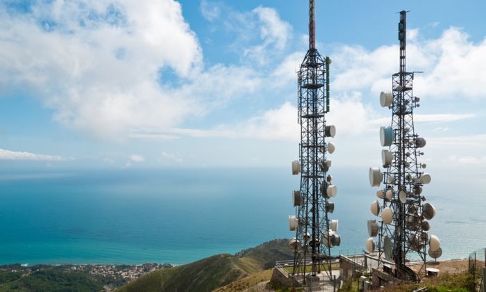 Two base stations on a mountain, with a blue sky behind them