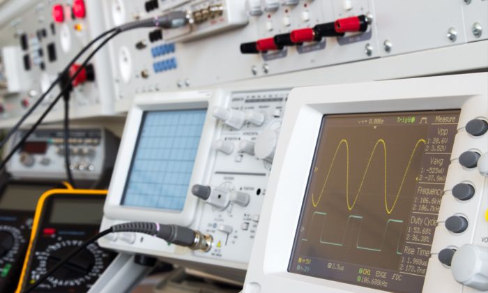 Several oscilloscopes and a multimeter